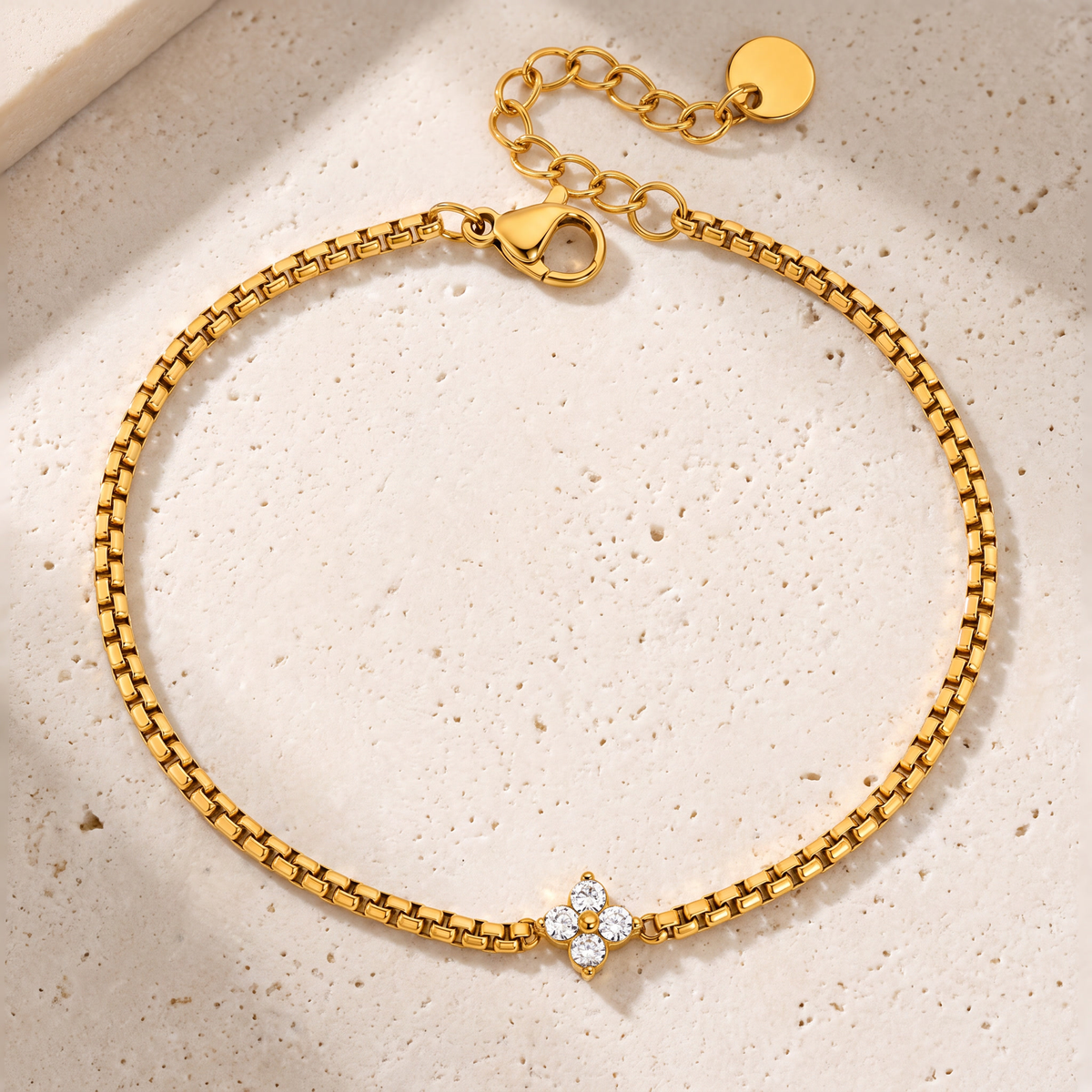 Isola Clover Box Chain Bracelet on travertine