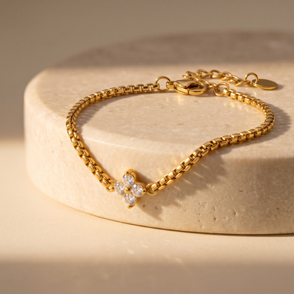 Isola Clover Box Chain Bracelet displayed on travertine
