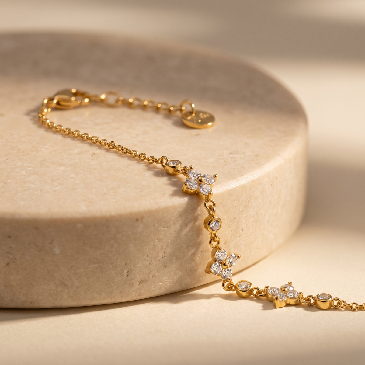 Juniper Clover Cluster Bracelet displayed on travertine